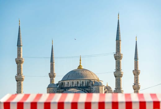 Yeni Cami Ottoman imperial mosque located in the Eminönü quarter of Istanbul, Turkey. Sunset sky in background.