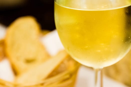 Blurred White Wine Focus on Glass Droplets in Restaurant Atmosphere