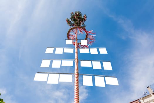 Blank White Signs on Traditional German May Pole Maibaum Blue Skies Local Tradition