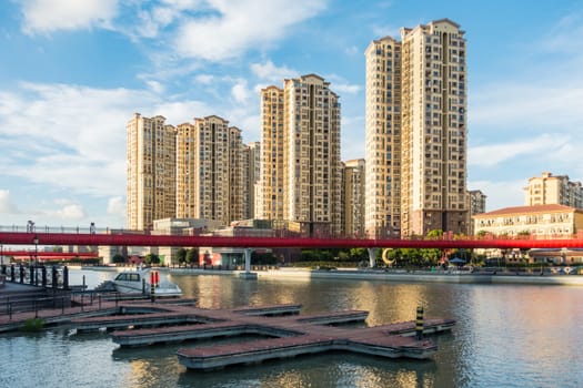 Daytime Upscale Apartments on River and Boating Area