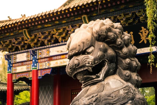 Chinese Guardian Lion Standing in front of the Gate