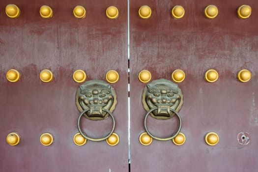 Chinese Traditional Gate with Lion Knockers on it