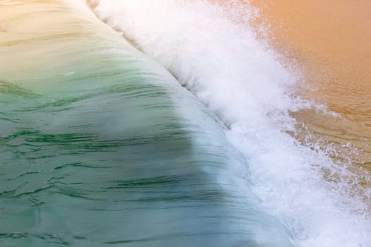 Ocean Wave Crashing on Sandy Beach Foam