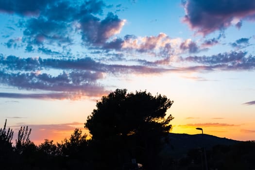 Beautiful Sunset Clouds over Mountains and Ocean in Croatia with Fiery Colors on Landscape