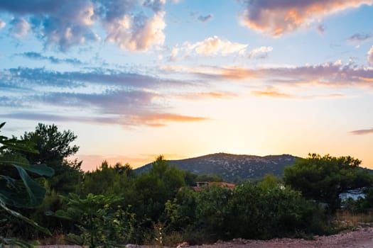 Beautiful Sunset Clouds over Mountains and Ocean in Croatia with Fiery Colors on Landscape