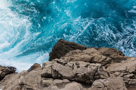 Rocky Cliff Contrast From Above with Crashing Blue Water Whitecaps  Perspective