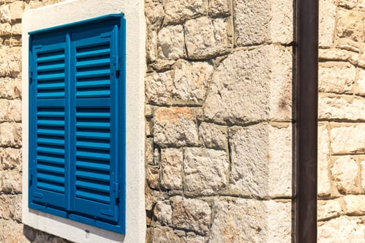 Bright Blue Vintage Window Shutters on Corners of Stone Building Village Old