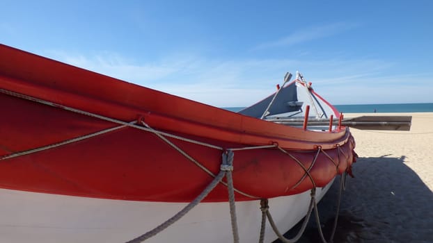 Bright Red Rowboat Ocean Landscape Beach Vacation Sandy Blue Sky Daytime