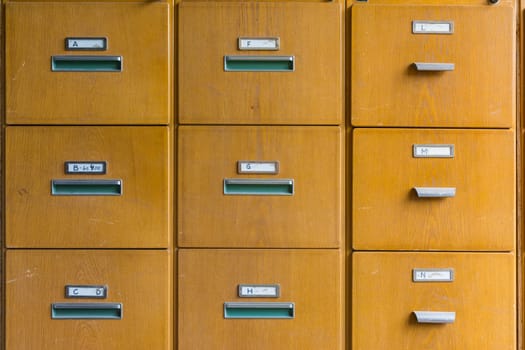 Wooden File Cabinet Straight On Geometric Pattern Squares Empty Labels Doors Closed Old Vintage Brown Office Supply