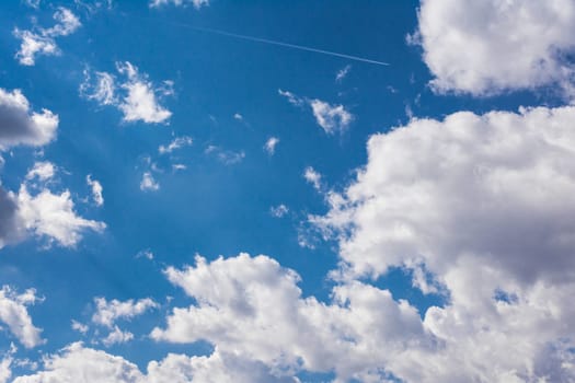 White Clouds Blue Sky Fluffy Sun Flare Airplane Trail  Sunny Daytime Texture Background