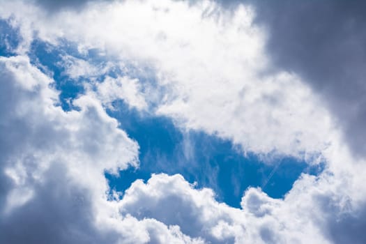 White Clouds Blue Sky Fluffy Sun Flare Airplane Trail  Sunny Daytime Texture Background