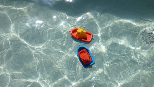 Children's Beach Toy Boats Bright Colored Floating in Clear Water
