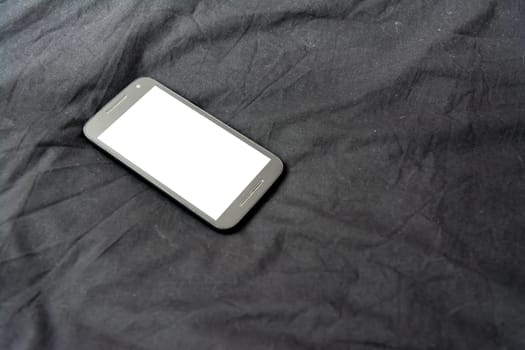 Cell Phone on Black Blanket White Screen Isolated Simple Background Fabric