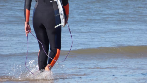 Surfer Legs Walking on Becah Holding Surfboard Ocean