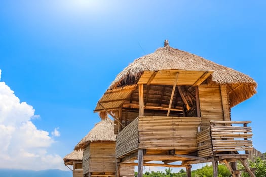 Row of Tiki Huts Sunny Beach Vacation Ocean Tropical Living