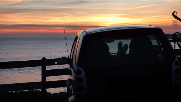 Sitting in Electric Car Cliffside Sunset Beach Ocean Landscape