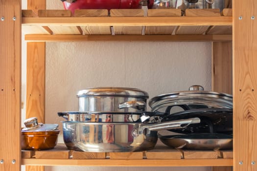 Pots and Pans on Wooden Kitchen Shelf Empty Space Cooking Equipment