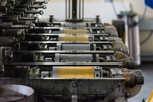 Golden Letterpress Cylinders Rustic Vintage Printing Method Metallic Rollers Four Color CMYK Print Closeup Machine Industrial Equipment