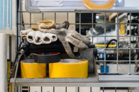 Gloves and Tape on Shelf in Factory Equipment General Industrial