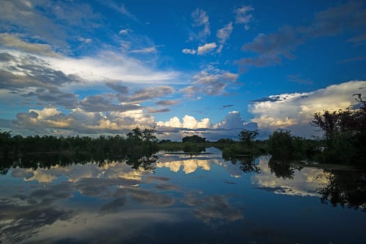 Landscape with standing water and reflection of clouds