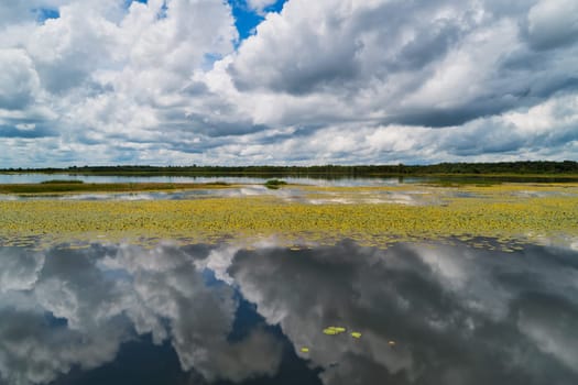Landscape with standing water and reflection of clouds