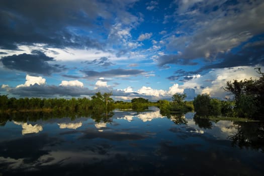 Landscape with standing water and reflection of clouds