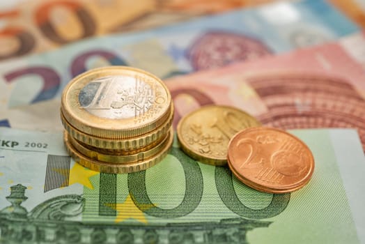 coins stack with euro bills
