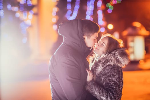 Young couple in love outdoor filtered photo with flash flare