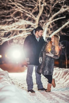 Happy pair loving each other in night park filtered photo with flash flare