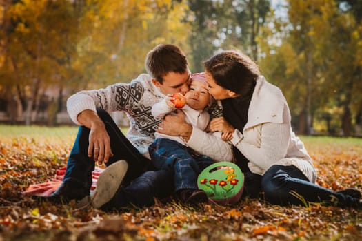 Happy mother, father and daughter in the park