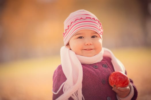 Beautiful outdoor autumn portrait of adorable toddler girl