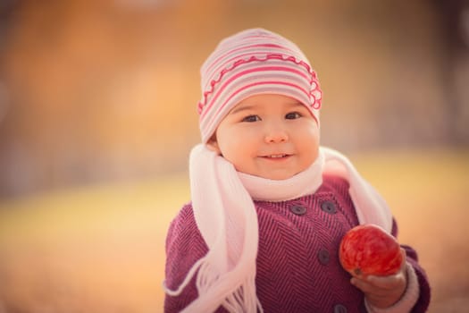 Beautiful outdoor autumn portrait of adorable toddler girl
