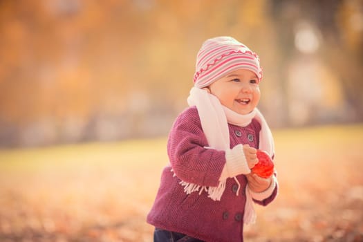 Beautiful outdoor autumn portrait of adorable toddler girl