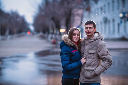 Portrait of young beautiful couple kissing in an autumn rainy day. Love and couple relationships concept.