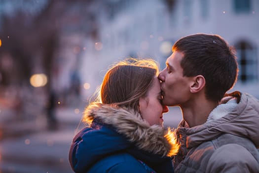 Portrait of young beautiful couple kissing in an autumn rainy day. Love and couple relationships concept.