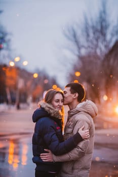 Portrait of young beautiful couple kissing in an autumn rainy day. Love and couple relationships concept.