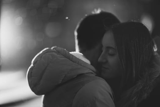 Close-up image of couple in love, man kisses a woman. Used filters instagram Black-white photo.