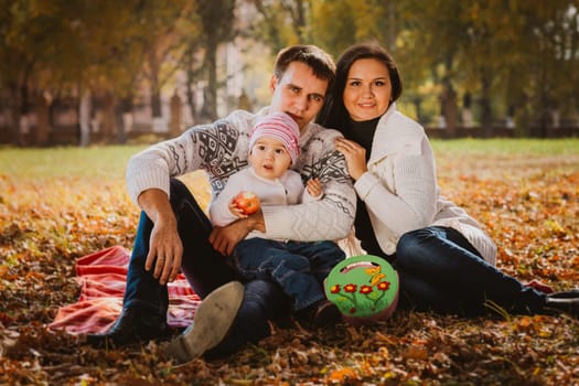 Happy mother, father and daughter in the park