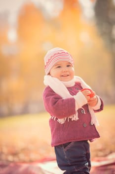 Beautiful outdoor autumn portrait of adorable toddler girl