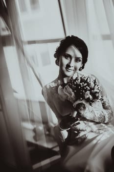 silhouette of the bride weared in dress and veil with a bouquet