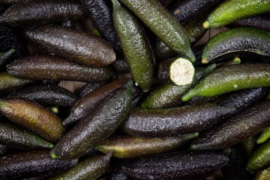 Raw organic Green Finger Limes as a background