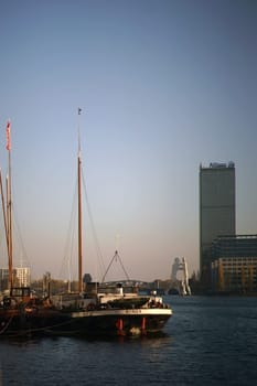 Berlin, Germany - November 06, 2018: Sailing ships on the banks of the Spree in front of the artwork "Molecule Man"" and the Allianz Hochhaus on November 06, 2018 in Berlin...."