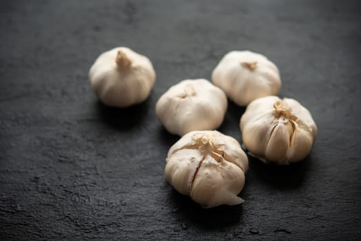 Garlic with copy space on dark background.