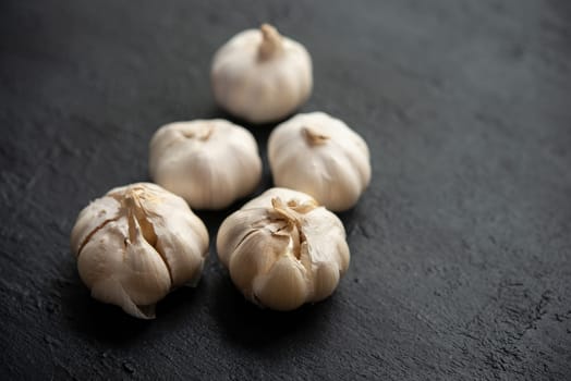 Garlic with copy space on dark background.