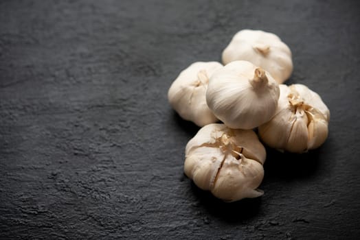 Top view garlic with copy space on dark background.