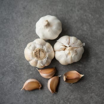 Top view garlic cloves and bulb on dark background.