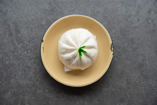 Flat lay Baozi or bao dim sum on plate on dark background.