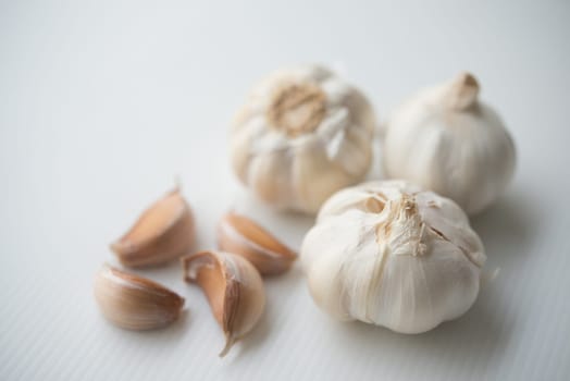 Garlic cloves and bulb on grey background.
