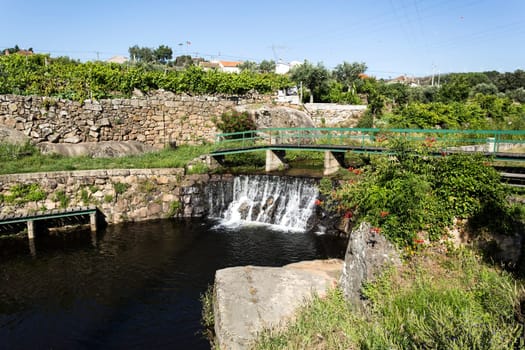 View of a recreational swimming facility created on a small river near the roman bridge in the village of Mesquitela, Gouveia, Portugal