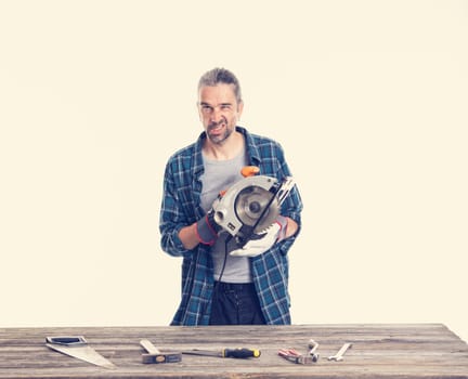 funny worker in blue plaid  shirt working with electric saw